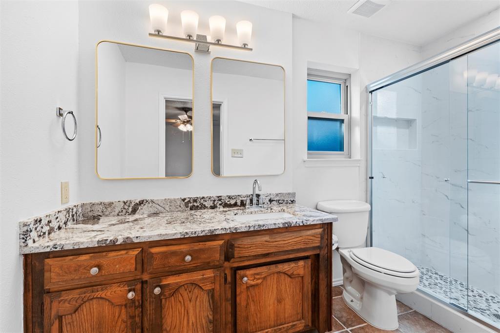 921 Red Oak Street Azle, TX 76020 - Photo 6 of 16 Primary bath with vanity, a marble finish shower, tile patterned floors, and ceiling fan