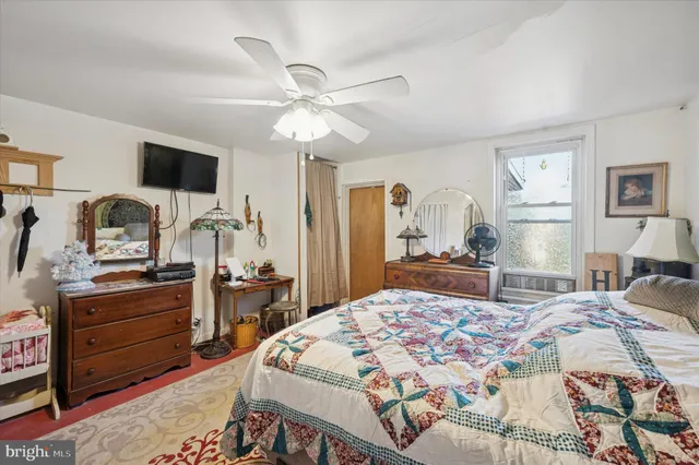 a bedroom with a bed and flat screen tv