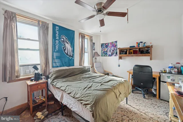 a bedroom that has a bed and a chair in it