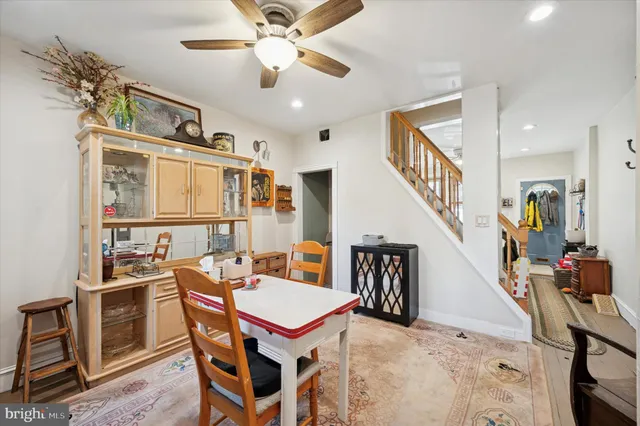 a dining room with furniture entryway and wooden floor