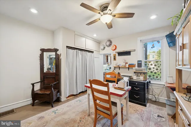 a dining room with furniture and window