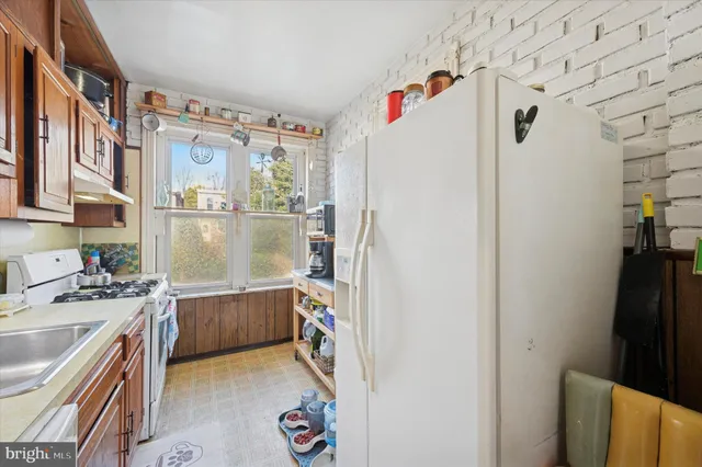 a kitchen with a refrigerator and a sink