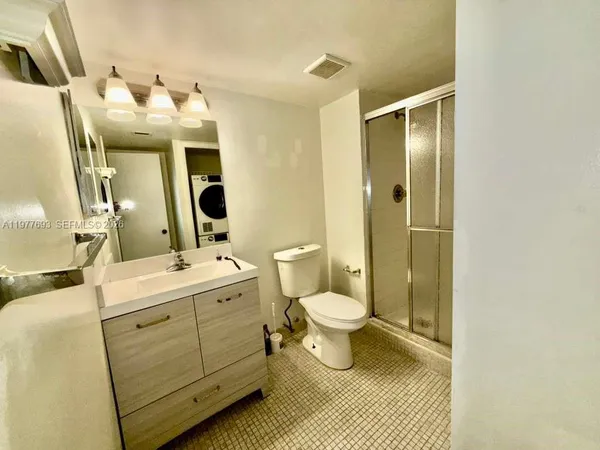 a bathroom with a sink and mirror with toilet