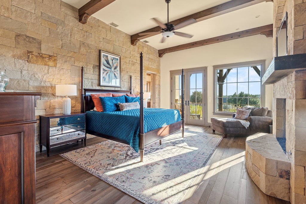 2328 Boot Ranch Circle Fredericksburg, TX 78624 - Photo 5 of 10 a bedroom with a bed and wooden floor