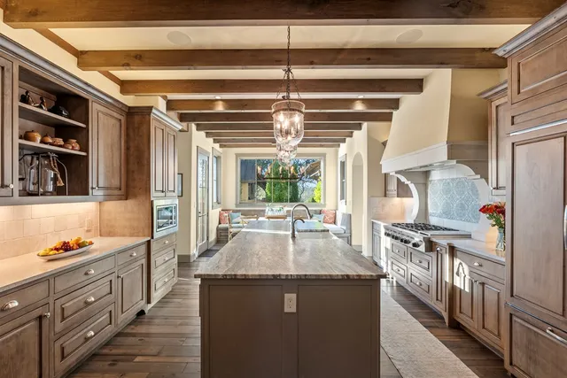 a kitchen with stainless steel appliances granite countertop a sink and stove