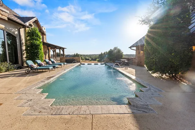 a view of a swimming pool with sitting area