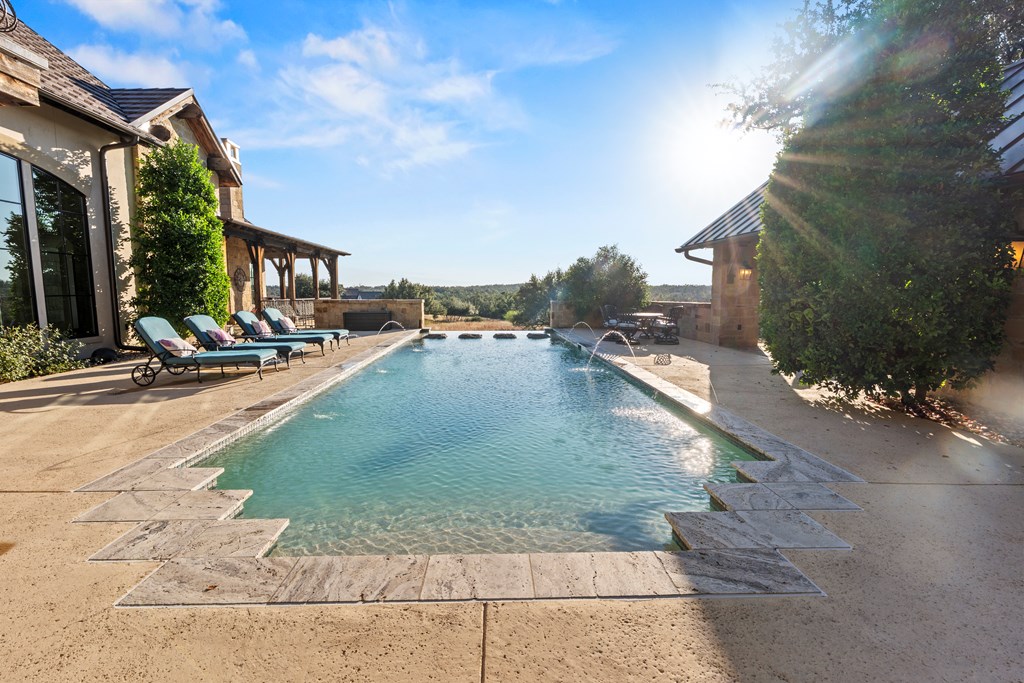 2328 Boot Ranch Circle Fredericksburg, TX 78624 - Photo 8 of 10 a view of a swimming pool with sitting area