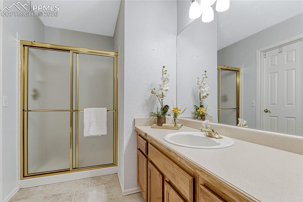15585 Falcon Ridge Court Colorado Springs, CO 80921 - Photo 28 of 50 a bathroom with a sink and a mirror