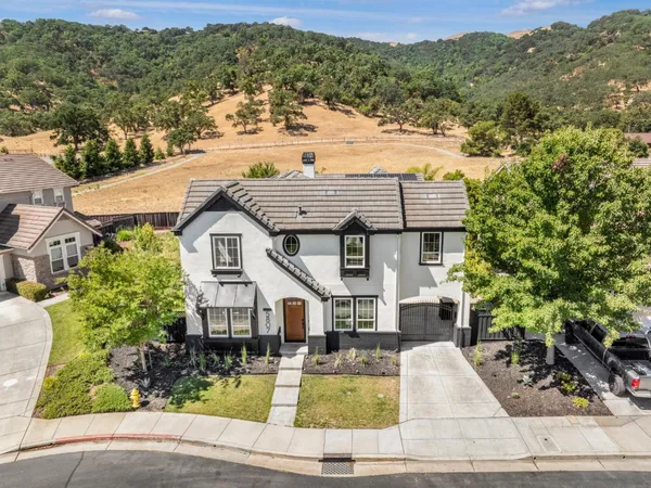 an aerial view of a house with a yard