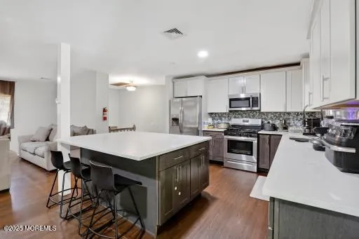 a kitchen with kitchen island wooden cabinets and counter space