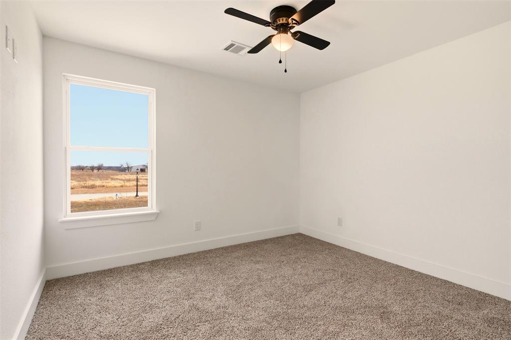 8902 Lowell Street Rowlett, TX 75089 - Photo 25 of 32 This room features light-colored walls and carpeted flooring
