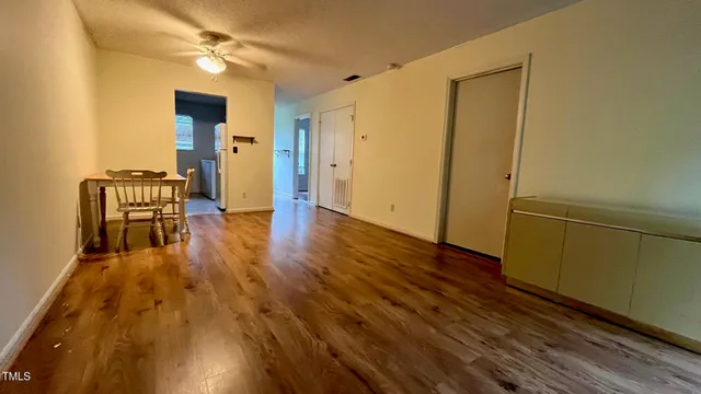 a white refrigerator freezer and a wooden floor