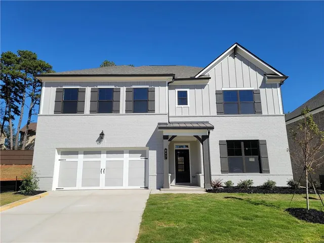 a front view of a house with a yard and garage