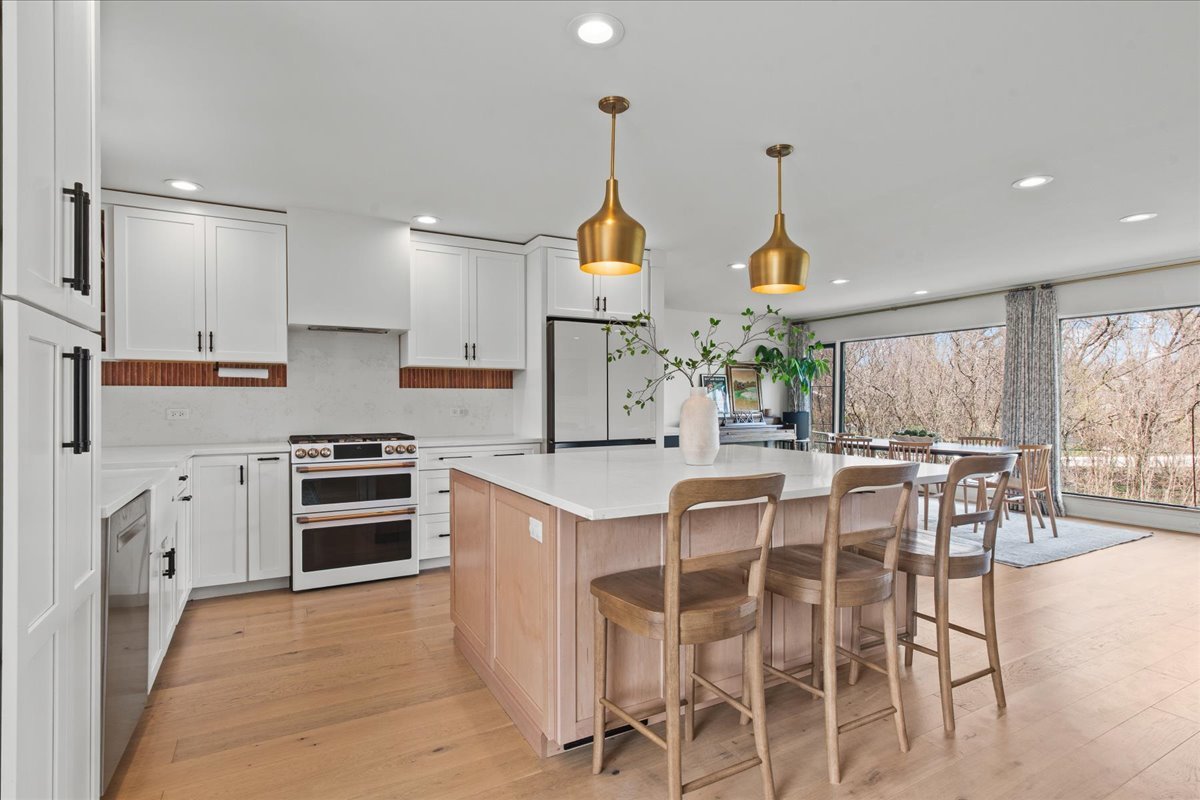 1975 Valley View Road Northfield, IL 60093 - Photo 13 of 45 a kitchen with granite countertop cabinets and chairs