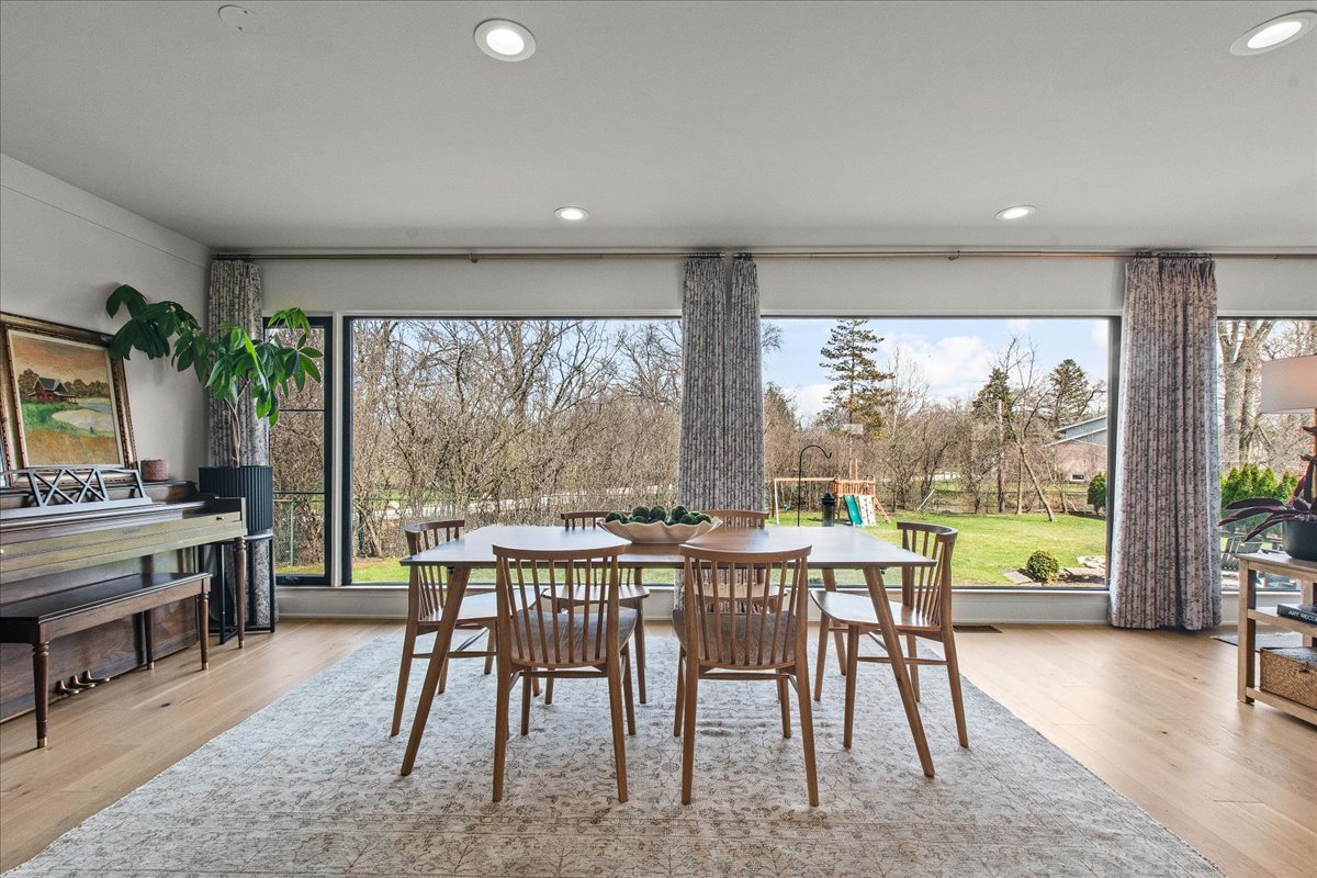 1975 Valley View Road Northfield, IL 60093 - Photo 15 of 45 a view of a dining room with furniture large windows and wooden floor