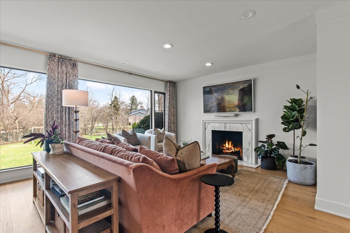 1975 Valley View Road Northfield, IL 60093 - Photo 19 of 45 a living room with furniture a fireplace and a floor to ceiling window