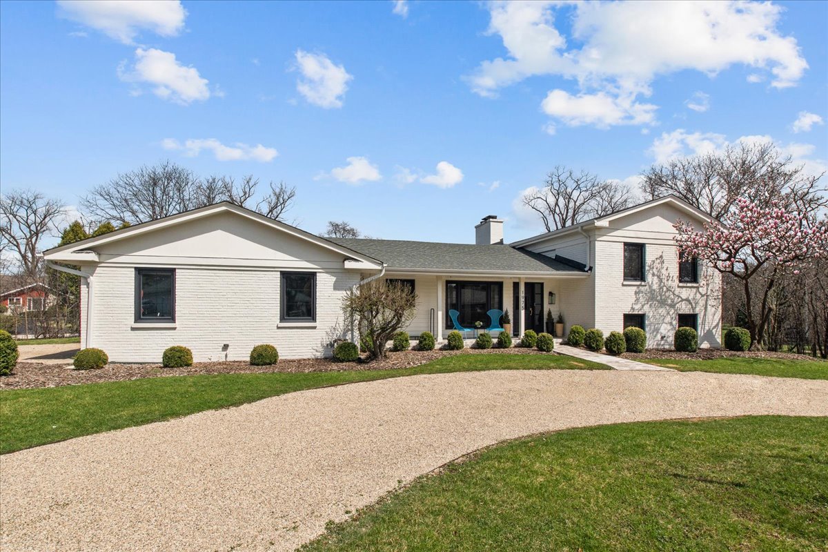 1975 Valley View Road Northfield, IL 60093 - Photo 2 of 45 a front view of a house with a yard and garage