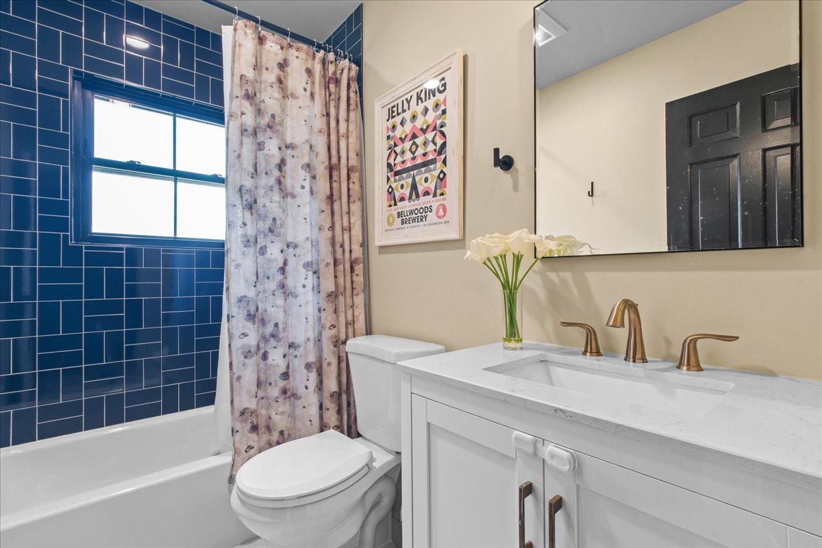 1975 Valley View Road Northfield, IL 60093 - Photo 22 of 45 a bathroom with a sink a toilet and shower