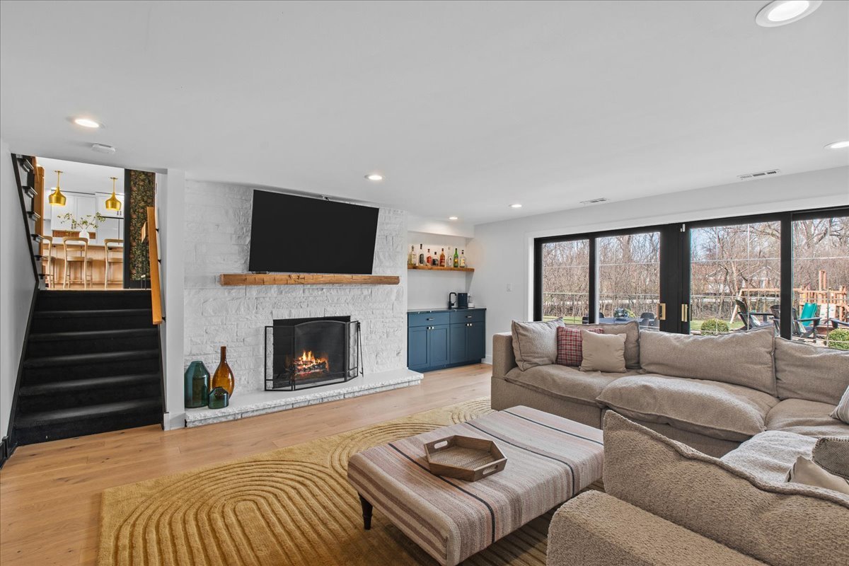 1975 Valley View Road Northfield, IL 60093 - Photo 33 of 45 a living room with furniture a fireplace and a flat screen tv