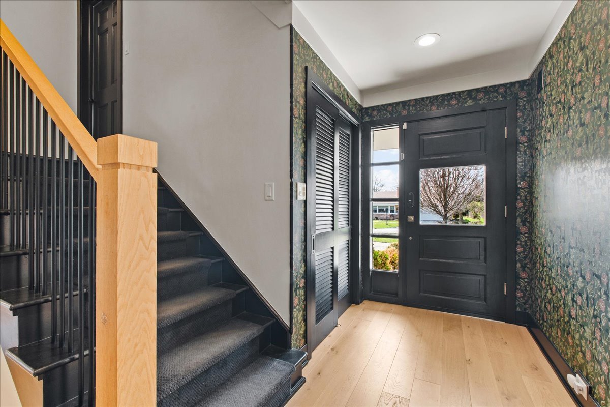 1975 Valley View Road Northfield, IL 60093 - Photo 6 of 45 a view of hallway with stairs and wooden floor
