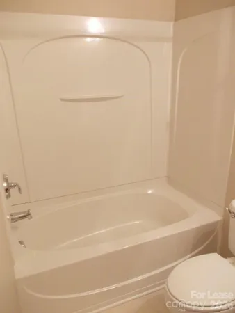 a bathroom with a shower and a toilet
