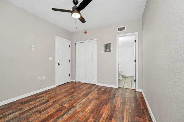 a view of empty room with wooden floor