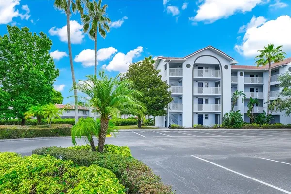 a front view of a residential apartment building with a yard