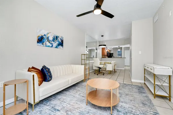 a living room with furniture and a dining table