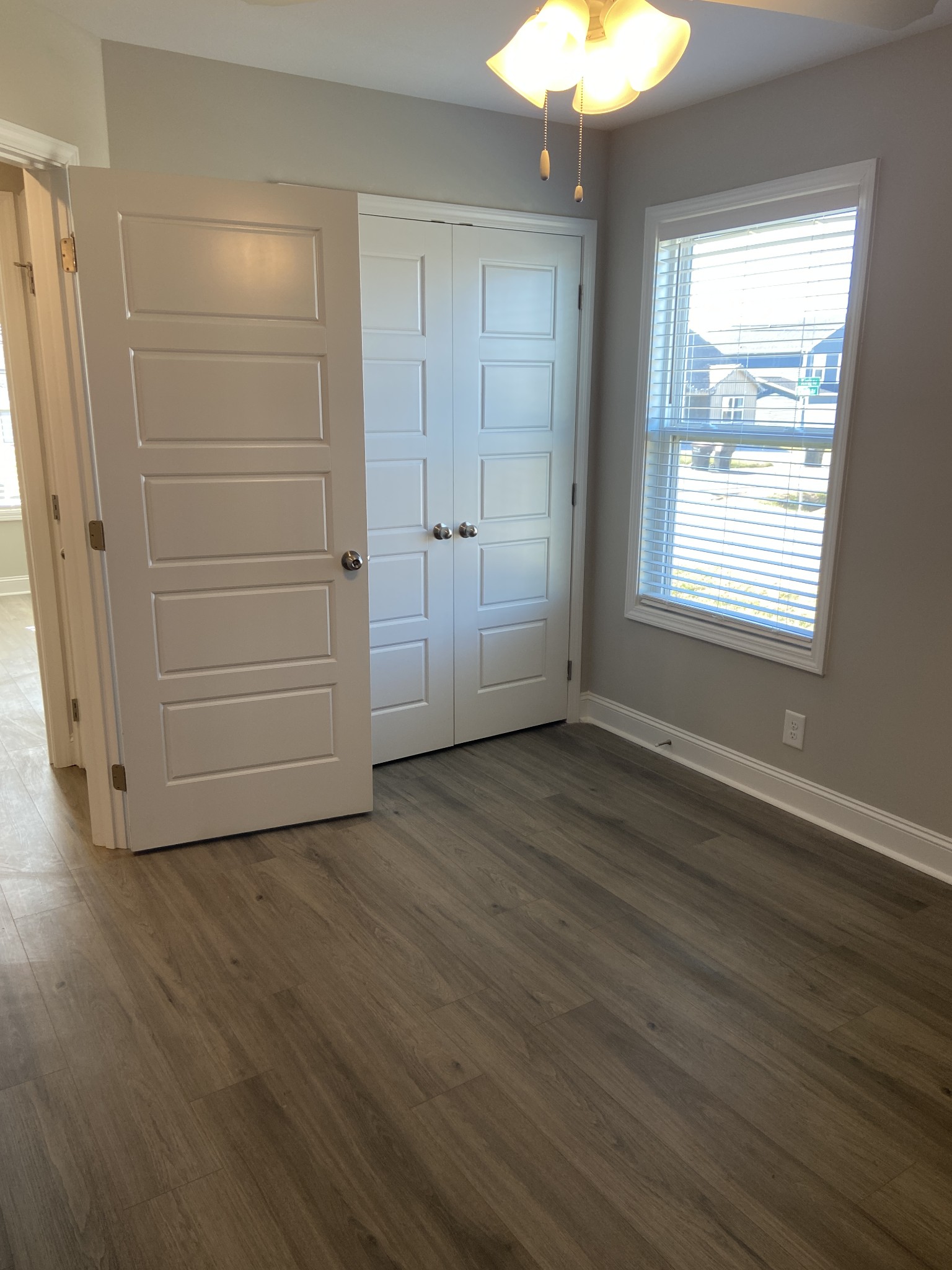 211 King Road Clarksville, TN 37042 - Photo 23 of 35 an empty room with wooden floor cabinet and windows