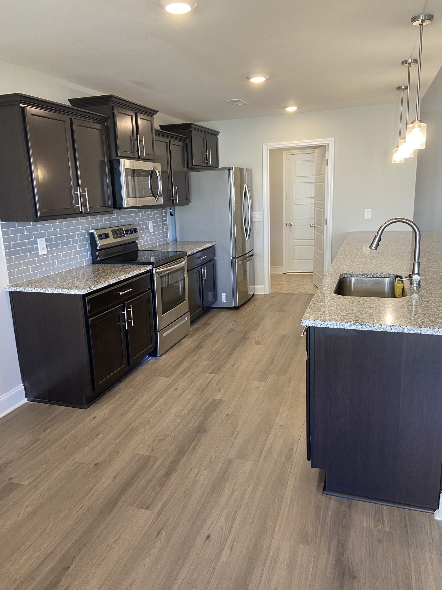 211 King Road Clarksville, TN 37042 - Photo 10 of 35 a large kitchen with stainless steel appliances granite countertop a sink a stove a microwave a counter space and cabinets