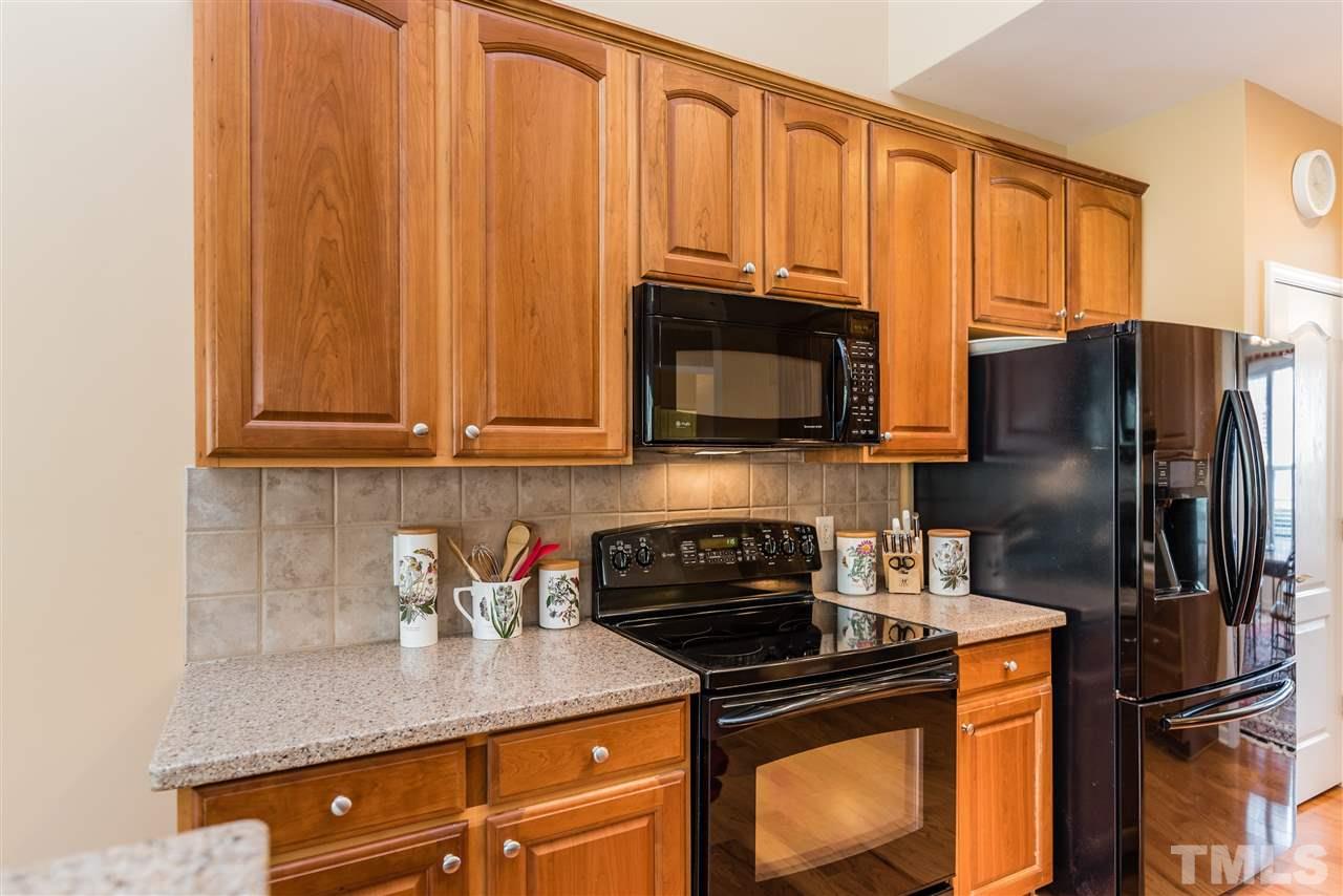 5112 Kate Denson Way Raleigh, NC 27612 - Photo 11 of 25 a kitchen with stainless steel appliances granite countertop a refrigerator stove top oven and sink
