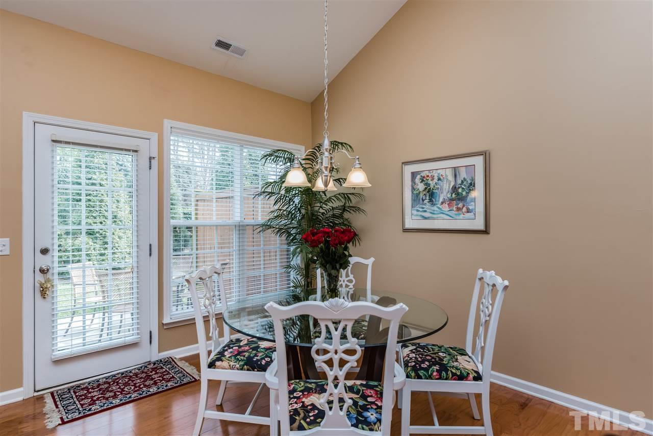 5112 Kate Denson Way Raleigh, NC 27612 - Photo 12 of 25 a view of a dining room with furniture wooden floor and chandelier