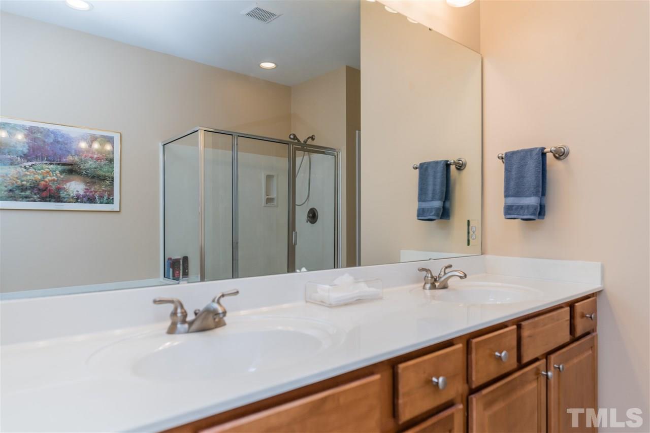 5112 Kate Denson Way Raleigh, NC 27612 - Photo 17 of 25 a bathroom with a double vanity sink and mirror