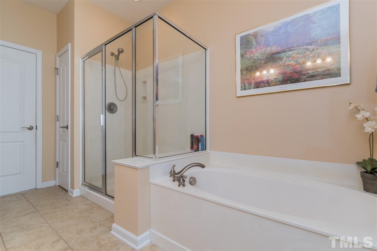 5112 Kate Denson Way Raleigh, NC 27612 - Photo 18 of 25 a bathroom with a bathtub and a shower