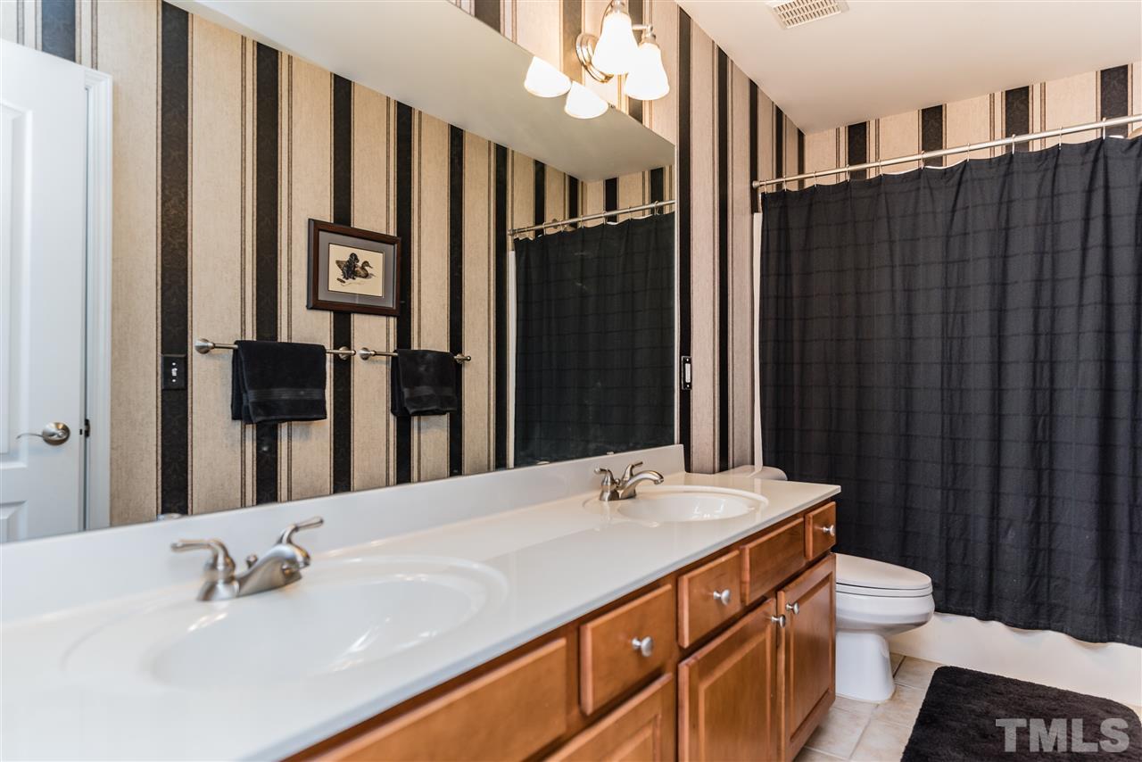 5112 Kate Denson Way Raleigh, NC 27612 - Photo 22 of 25 a bathroom with a double vanity sink and a mirror