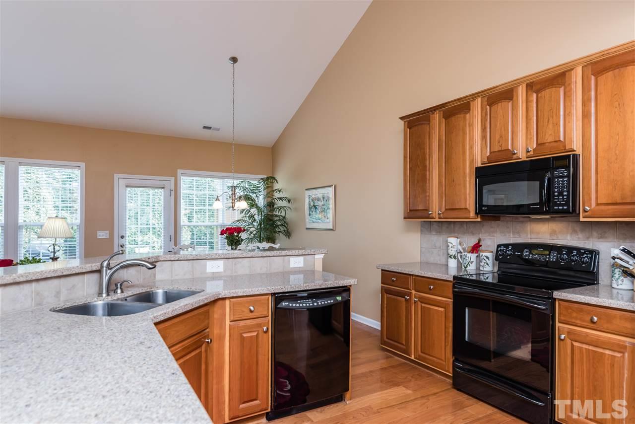 5112 Kate Denson Way Raleigh, NC 27612 - Photo 8 of 25 a kitchen with stainless steel appliances granite countertop a sink stove and microwave