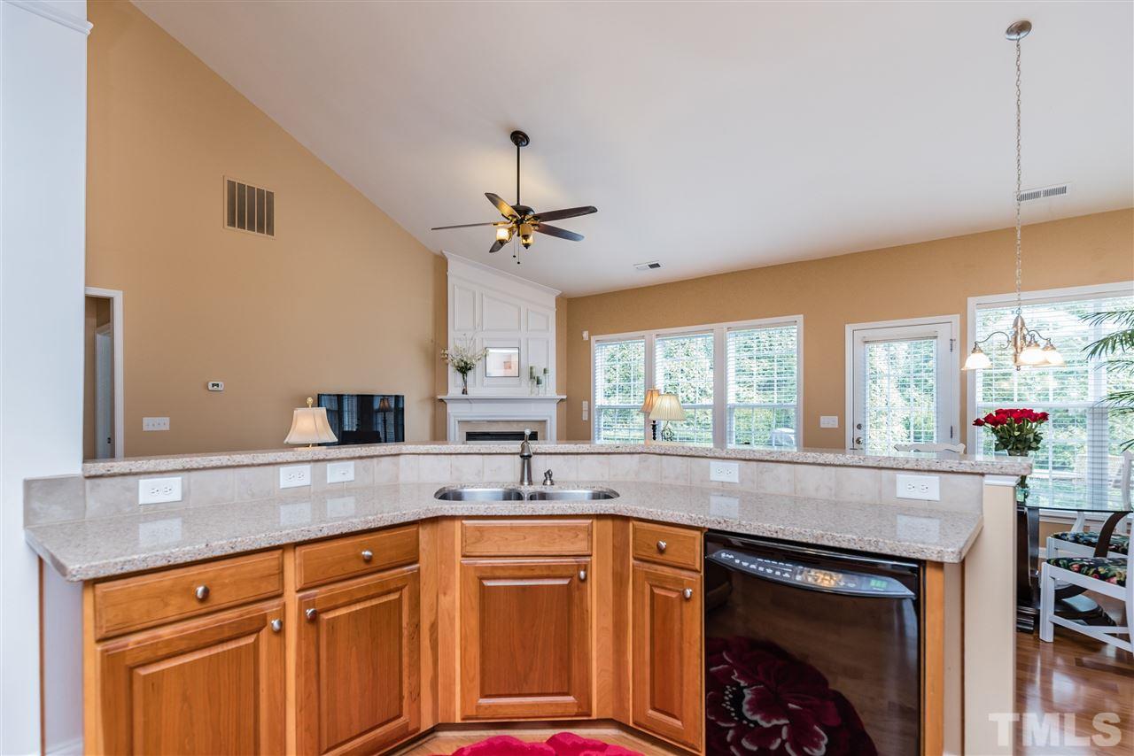 5112 Kate Denson Way Raleigh, NC 27612 - Photo 10 of 25 a kitchen with stainless steel appliances granite countertop a sink and cabinets