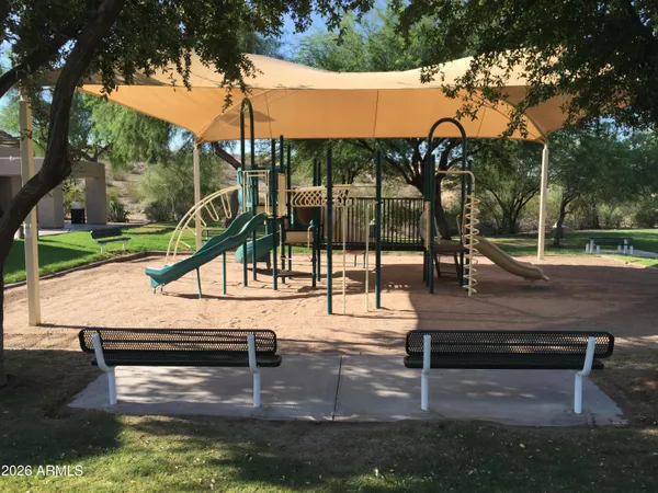 a park with wooden stairs and a bench