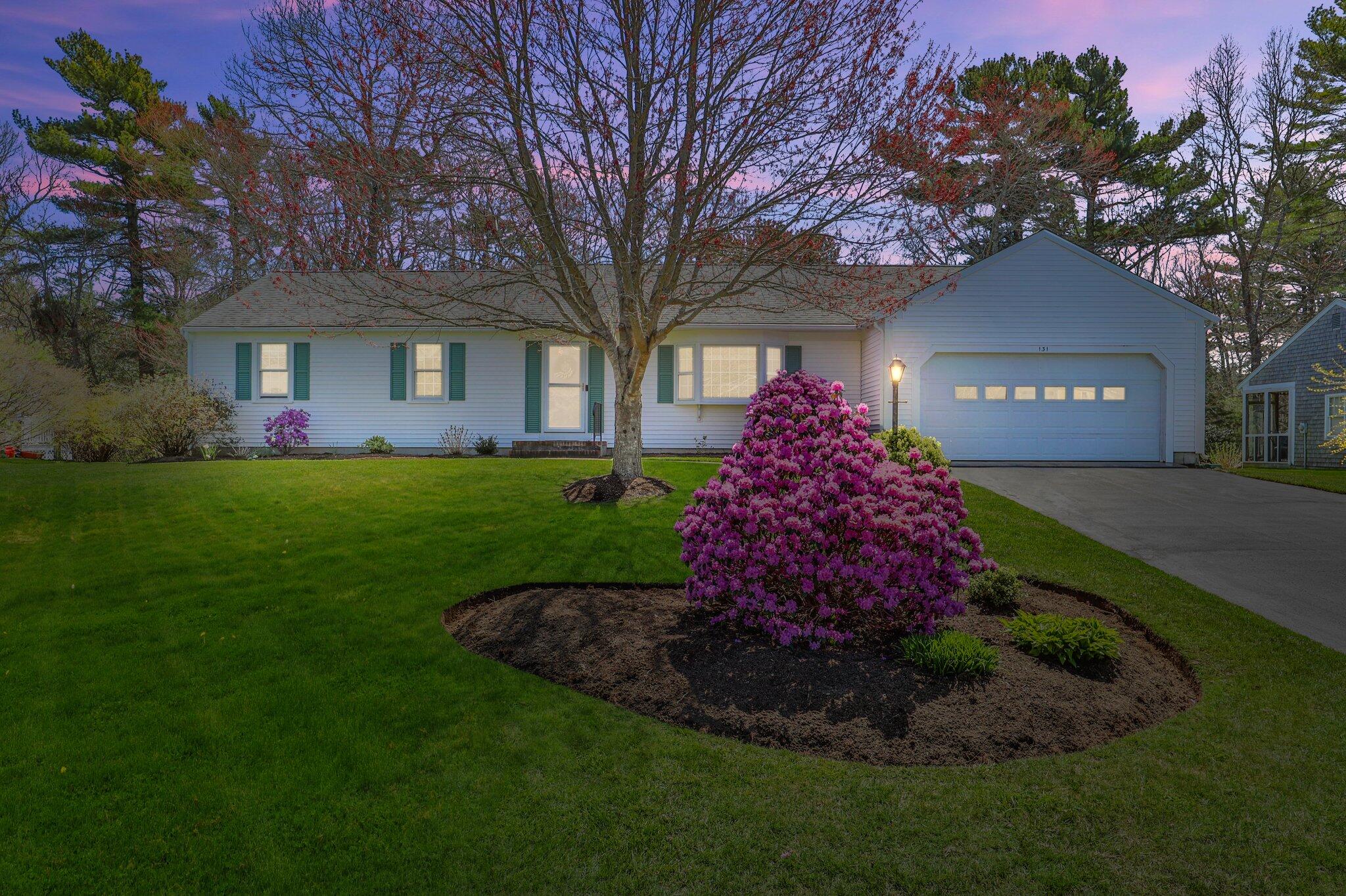 131 Seth Parker Road Centerville, MA 02632 - Photo 1 of 55 a front view of a house with a garden and trees