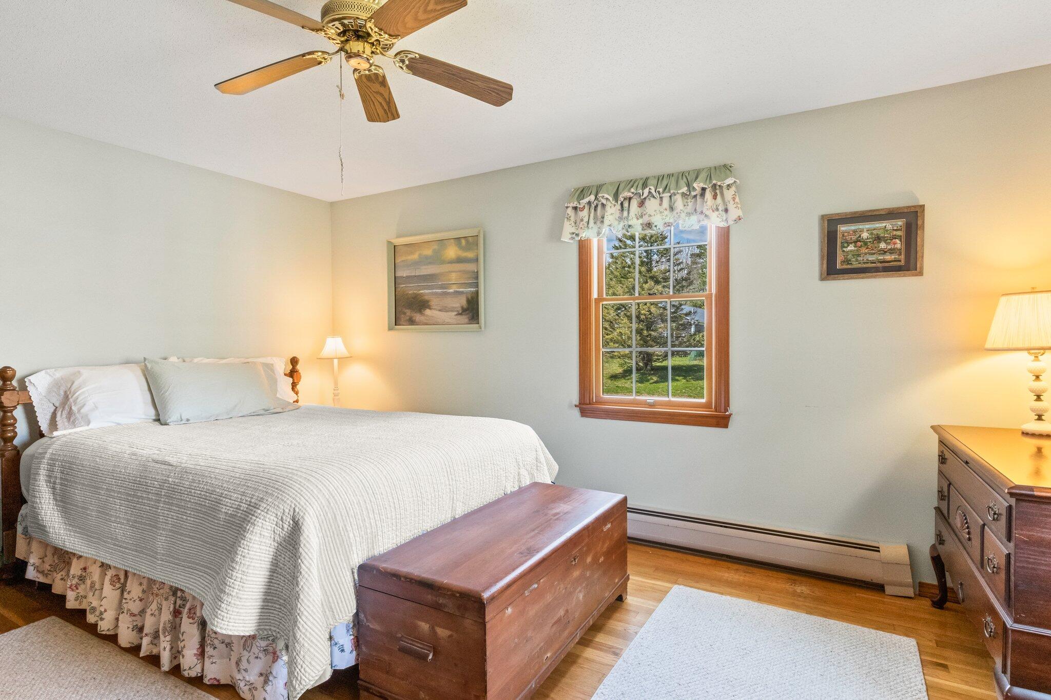 131 Seth Parker Road Centerville, MA 02632 - Photo 13 of 55 a bedroom with a bed and a chandelier