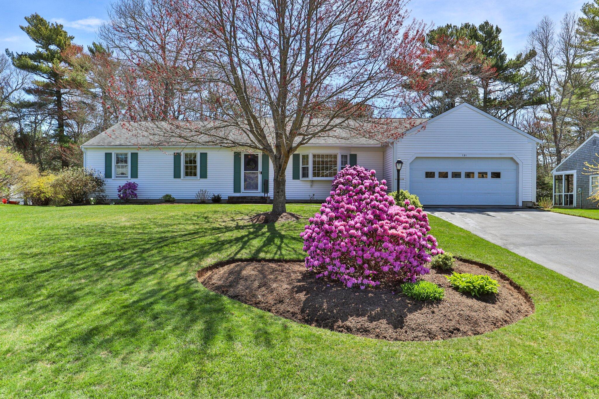 131 Seth Parker Road Centerville, MA 02632 - Photo 20 of 55 a front view of a house with a garden and trees