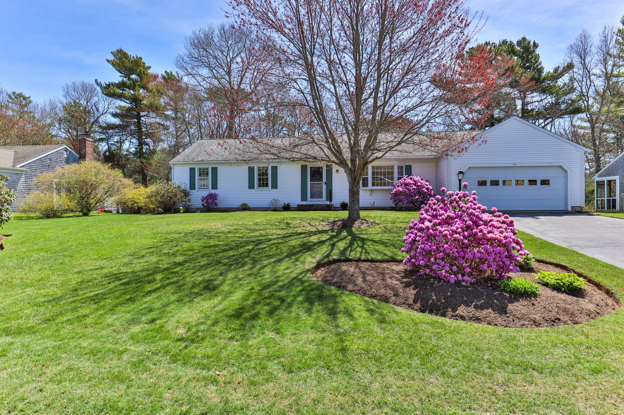 131 Seth Parker Road Centerville, MA 02632 - Photo 21 of 55 a front view of a house with a garden and trees