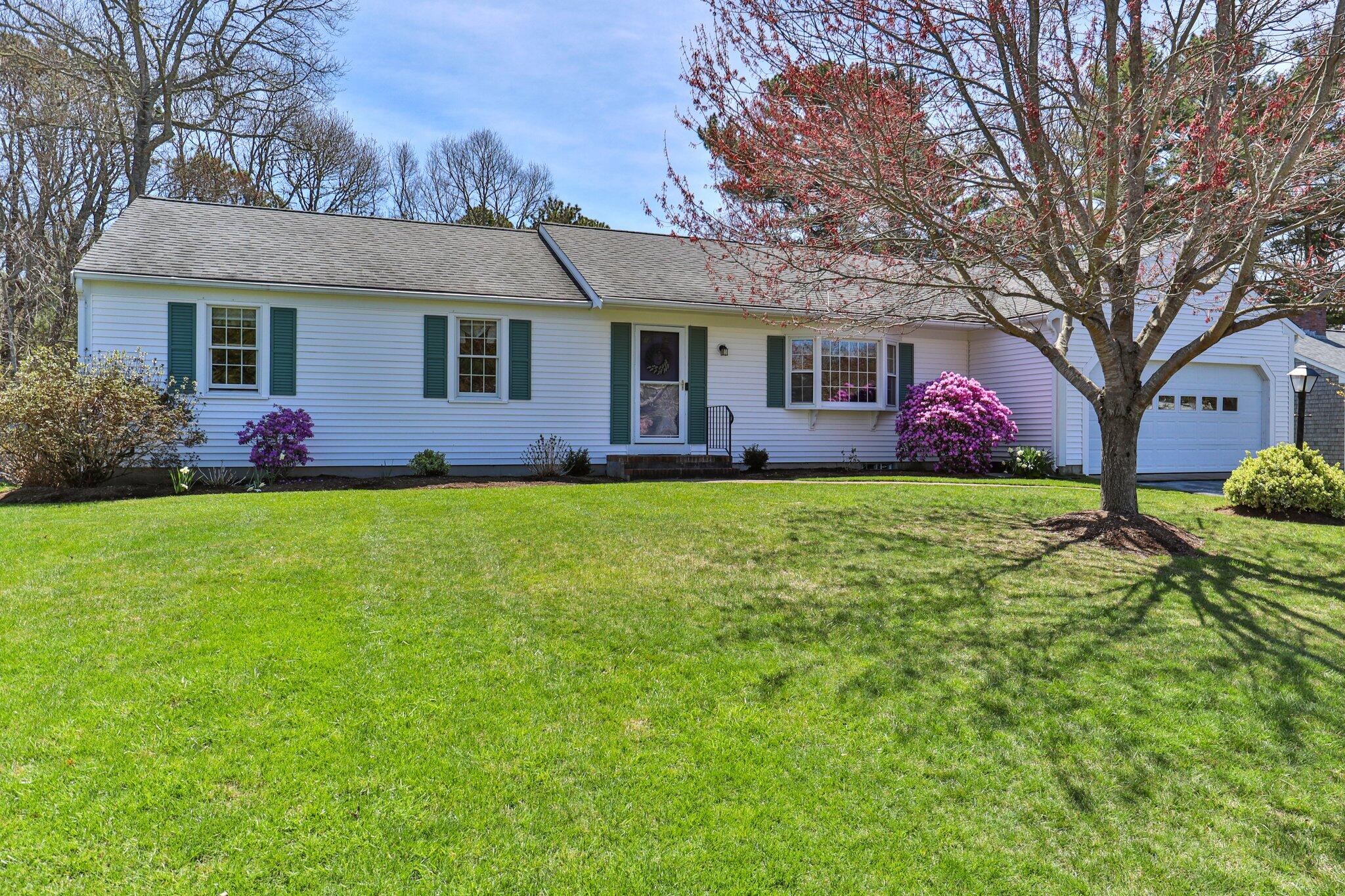 131 Seth Parker Road Centerville, MA 02632 - Photo 23 of 55 a view of a yard in front of a house with plants and large tree