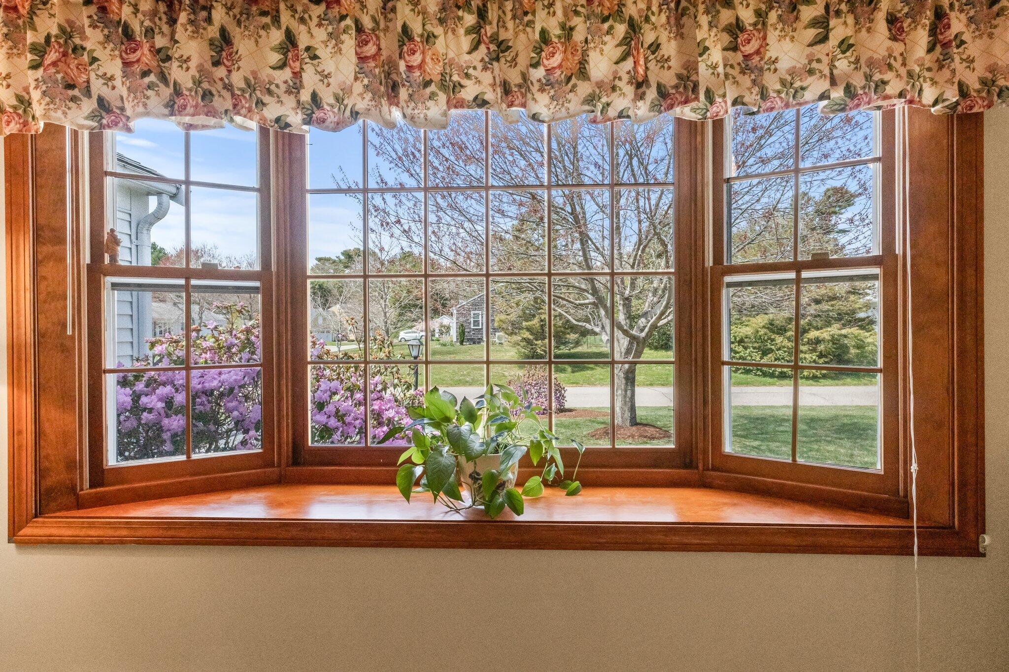 131 Seth Parker Road Centerville, MA 02632 - Photo 26 of 55 a view of a dining room with floor to ceiling window and wooden floor