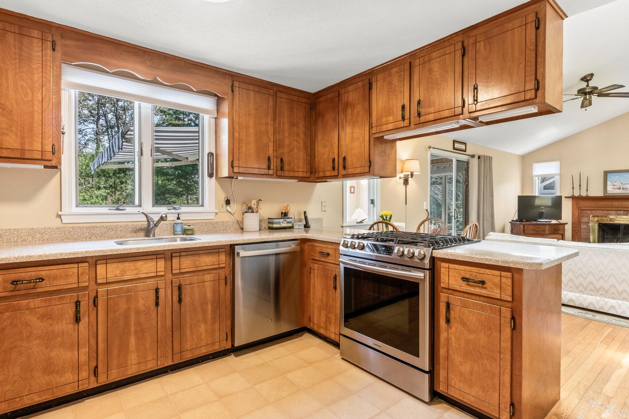 131 Seth Parker Road Centerville, MA 02632 - Photo 30 of 55 a kitchen with granite countertop cabinets stainless steel appliances and a sink