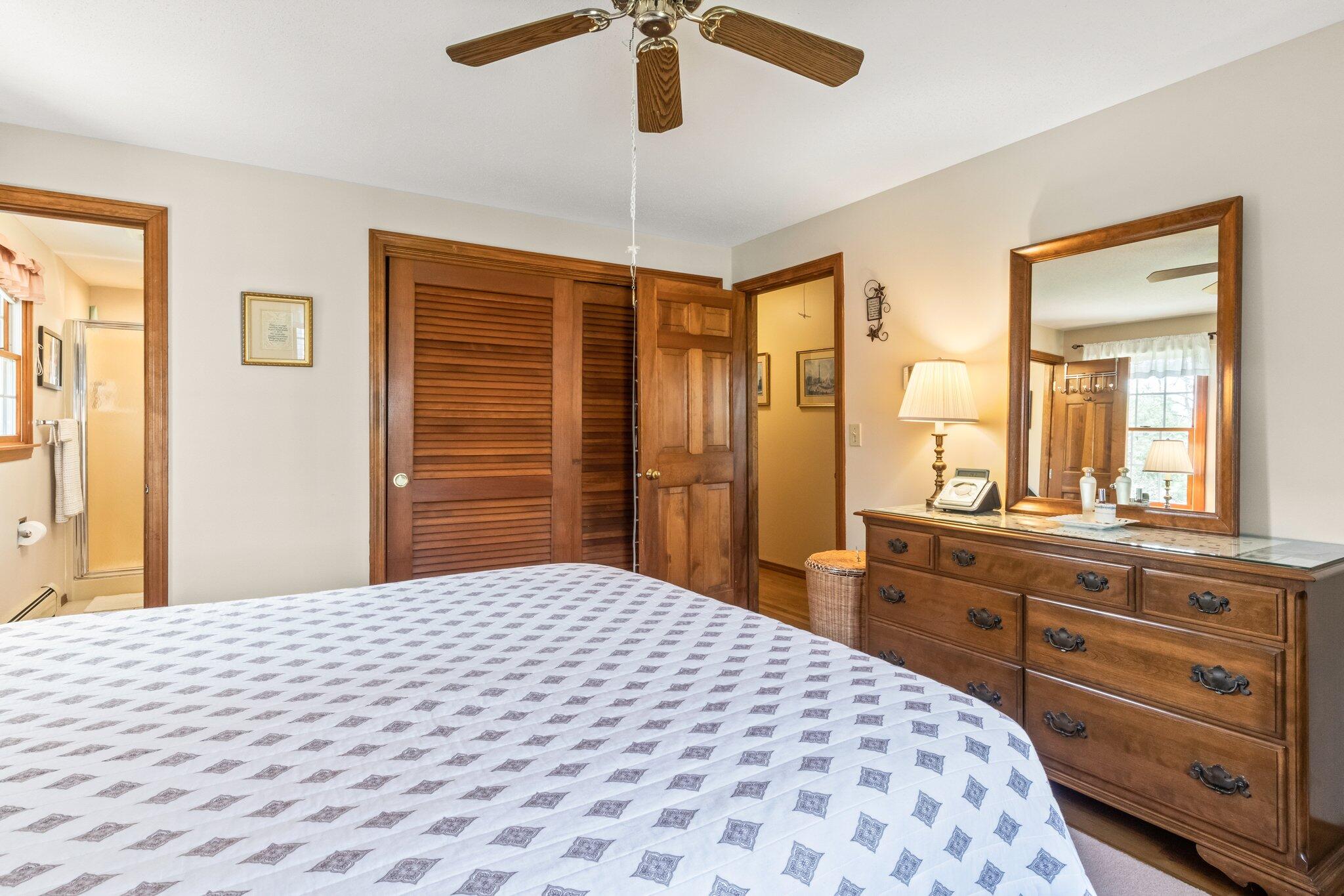 131 Seth Parker Road Centerville, MA 02632 - Photo 38 of 55 a bedroom with a large bed and a dresser