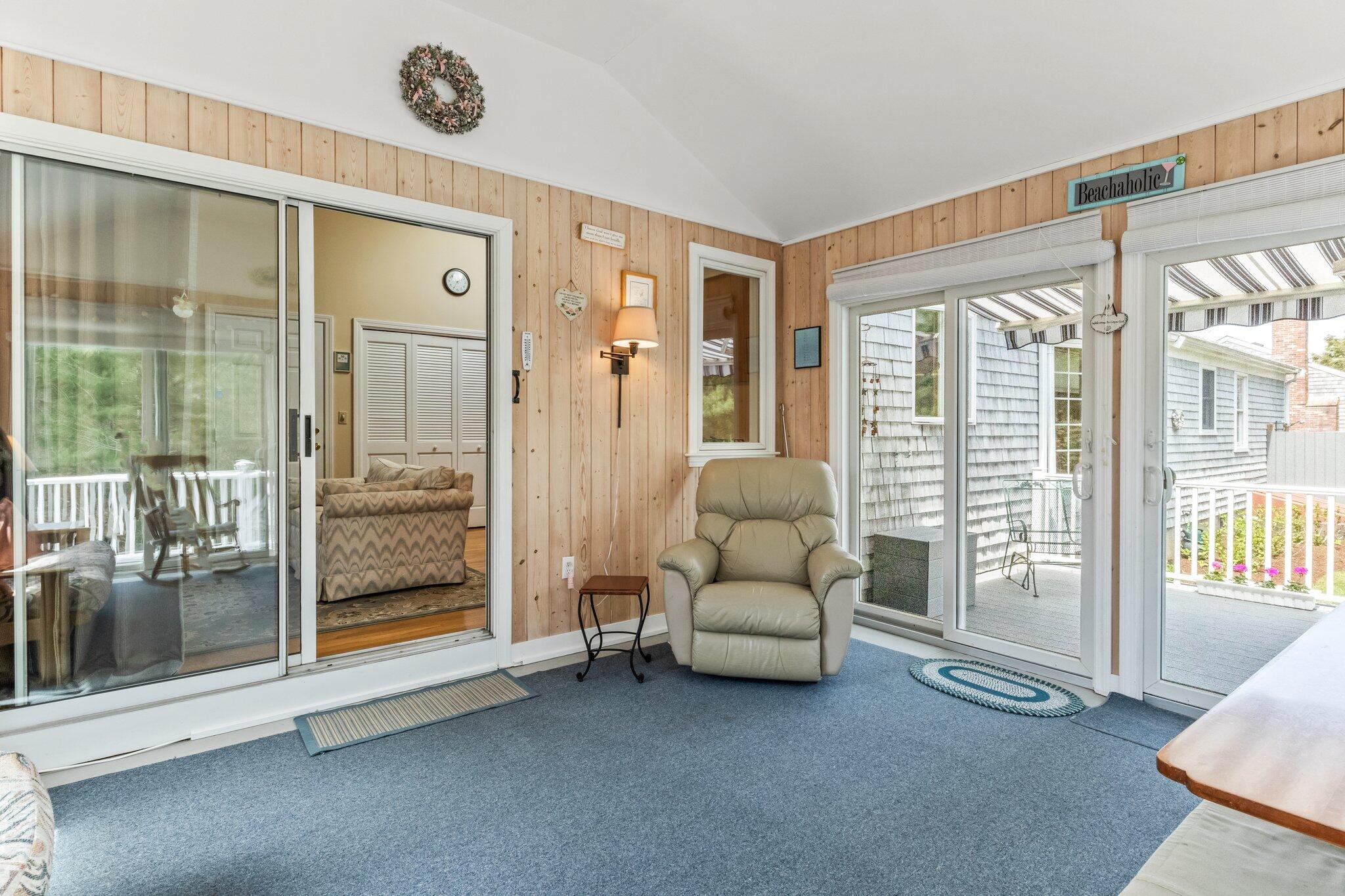 131 Seth Parker Road Centerville, MA 02632 - Photo 39 of 55 a living room with furniture and a floor to ceiling window