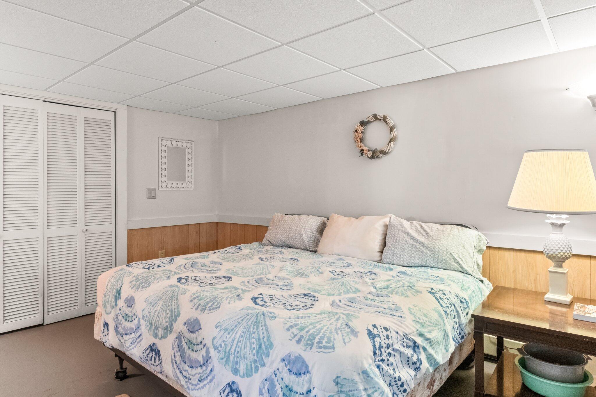 131 Seth Parker Road Centerville, MA 02632 - Photo 43 of 55 a bedroom with a bed and a lamp