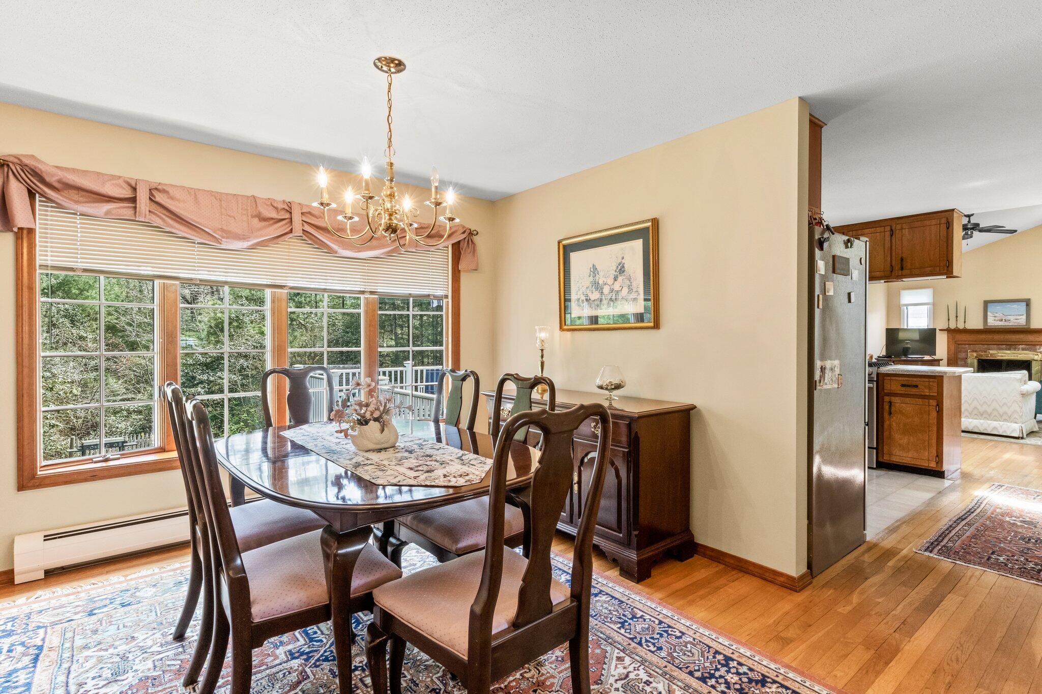 131 Seth Parker Road Centerville, MA 02632 - Photo 6 of 55 a view of a dining room with furniture large window and wooden floor