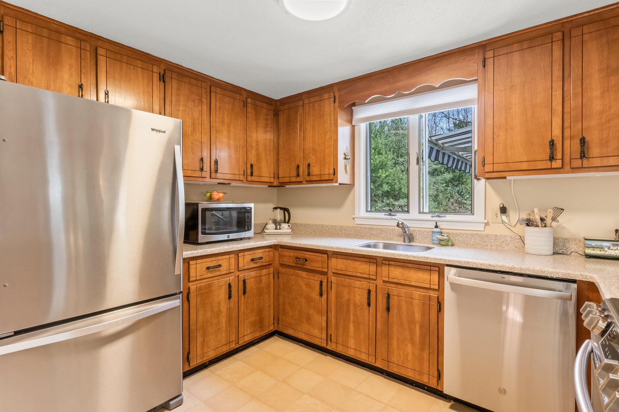 131 Seth Parker Road Centerville, MA 02632 - Photo 7 of 55 a kitchen with stainless steel appliances a refrigerator sink and cabinets